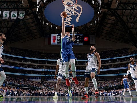 Luka Doncic (No 77) of the Dallas Mavericks drives to the basket during the game against the Minnesota Timberwolves at the American Airlines Center in Dallas, Texas.