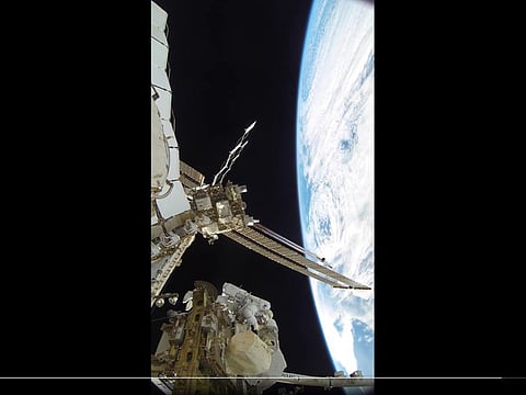 Still from clip showing Al Neyadi between Earth and the space station