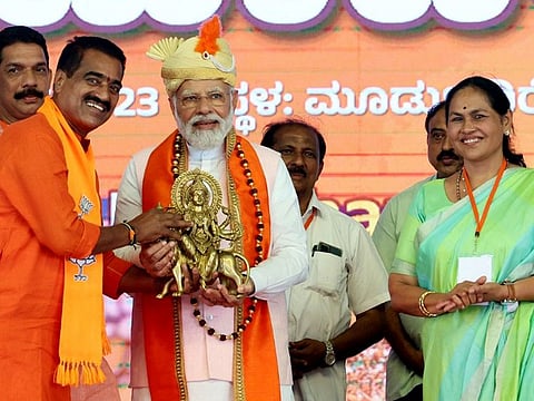 Prime Minister Narendra Modi being felicitated during an election rally ahead of Karnataka assembly elections in Mudbidri, Karnataka, on April 3, 2023. Modi himself has been campaigning hard, attacking the Congress for corruption and dynastic rule.