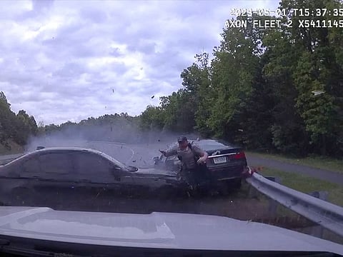 A police officer narrowly escapes a high-speed crash, in Fairfax County, Virginia, U.S., May 1, 2023, in this screen grab from a social media video.