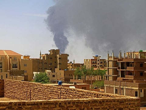 Smoke billows over residential buildings in Khartoum on May 1, 2023 as deadly clashes between rival generals' forces entered third week.