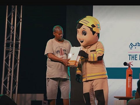 Still from video showing a worker receiving a gift during the event organised by PCLA in Dubai on International Workers’ Day (May 1)