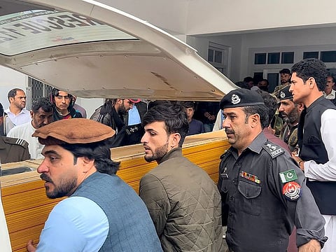 People carry a teacher's dead body into an ambulance from a hospital after violence inside a school in Parachinar, in Kurram district on May 4, 2023. - Five teachers and two labourers were gunned down on May 4 at a school in northwest Pakistan, in an attack linked to Sunni-Shiite sectarian tensions, police and government officials said.