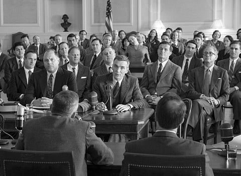 Cillian Murphy, centre, in a scene from 'Oppenheimer'.