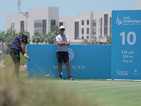 Cameron Van Rooyen watching Ahmad tee off