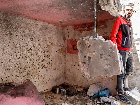 A Palestinian man looks at the site where Israeli forces killed Palestinian gunmen in a raid, according to the Israeli military, in Nablus in the West Bank May 4, 2023.