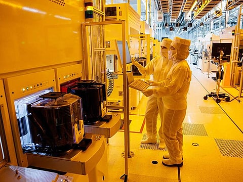 File photo: Employees of German semiconductor manufacturer Infineon Technologies AG work in a clean room on the production line of 200-millimeter wafers at the company's plant in Dresden, eastern Germany.