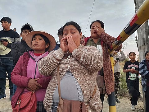 Relatives of trapped miners wait outside the SERMIGOLD mine in Arequipa, Peru