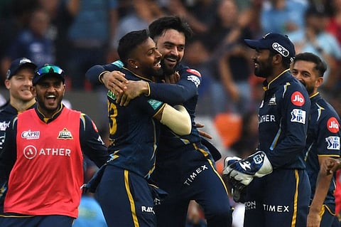 Gujarat Titans' Rashid Khan (centre) celebrates with teammates after taking a catch to dismiss Lucknow Super Giants' Kyle Mayers on Sunday.