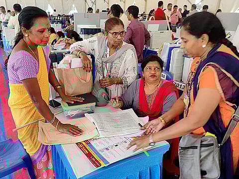 Polling officials collecting EVMs and VVPATs at the Mustering Centre on the eve of the Karnataka Assembly elections, at RV Engineering College, Yeswanthpur, in Bengaluru on Tuesday.