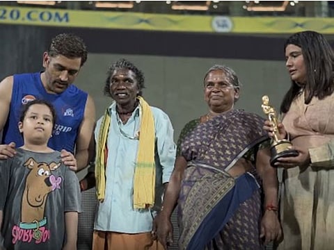 Mahendra Singh Dhoni with Bomman and Bellie, the elephant caregivers, and Oscar-winning filmmaker Kartiki Gonsalves.