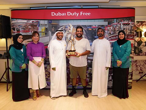 Ahmed Al Marar receiving the DDF UAE Nationals Cup trophy from Yousef Al Khalid of Dubai Duty Free along with Jasmin Micoyco and Akram Skaik.