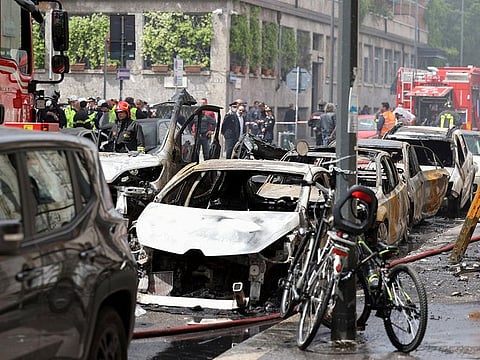 Firefighters work at the site of an explosion in the centre of Milan, Italy, on May 11, 2023.