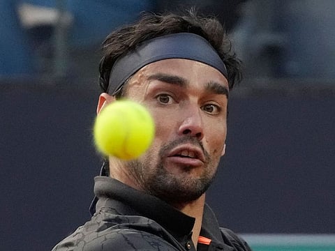 Italy's Fabio Fognini returns the ball to Britain's Andy Murray during their match at the Italian Open.