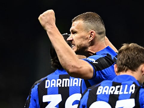 Inter Milan's Bosnian forward Edin Dzeko celebrates after opening the scoring during the Uefa Champions League semifinal first leg against AC Milan.