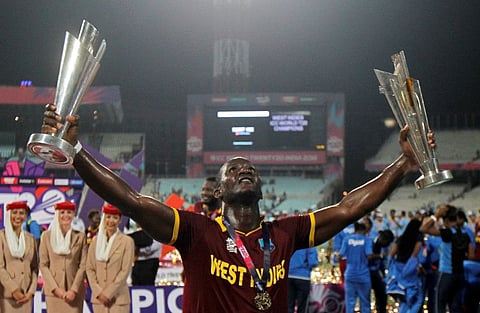 West Indies captain Darren Sammy holds trophies after winning World Cup Twenty20 final.