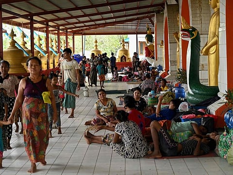People shelter at a monastery in Sittwe town in Myanmars Rakhine state on May 12, 2023, ahead of the expected landfall of Cyclone Mocha.