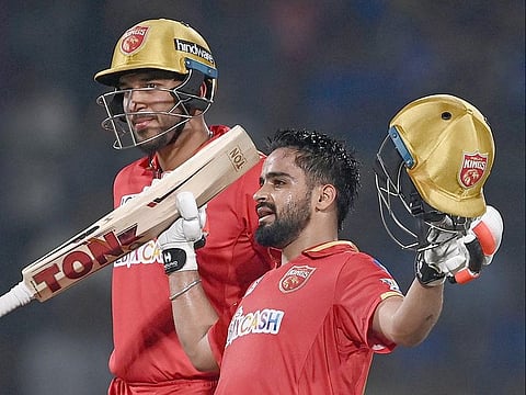 Punjab Kings' Prabhsimran Singh (R) celebrates after scoring a century during the IPL match against Delhi Capitals at the Arun Jaitley Stadium in New Delhi on May 13, 2023.