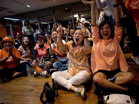 Supporters of the Move Forward Party react as they watch results come in at the party headquarters in Bangkok after polls closed in Thailand's general election.