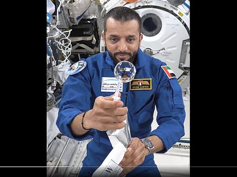 Still from video showing Al Neyadi making a floating water bubble to demonstrate the effect of microgravity on liquids inside the International Space Station
