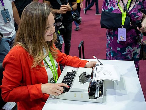 Keira Rathbone types out an artwork at the Sharjah festival. She started seeing letters as shapes and textures 20 years ago.