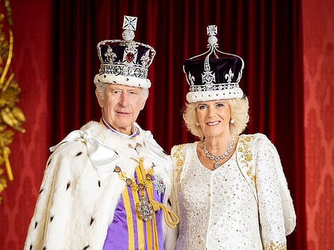 Britain's King Charles III and Britain's Queen Camilla posing in the Throne Room at Buckingham Palace, in London.