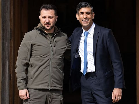Britain's Prime Minister Rishi Sunak (right) greets Ukraine's President Volodymyr Zelensky at Chequers, the prime minister's official country residence, near Ellesborough, northwest of London, on May 15, 2023. Ukraine's President Volodymyr Zelensky arrived in Britain on Monday to meet Prime Minister Rishi Sunak, who pledged "hundreds" of both air-defence missiles and long-range attack drones to fend off Russia's attacks.