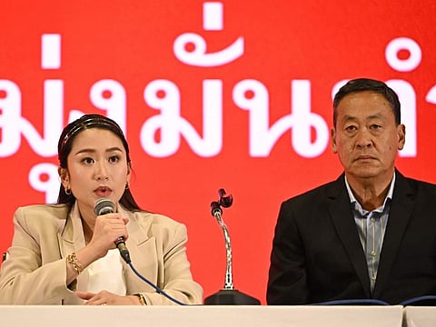 Pheu Thai Party's prime ministerial candidates Paetongtarn Shinawatra (left) and Srettha Thavisin address the media at the party's headquarters in Bangkok on May 15, 2023. Thailand's opposition Pheu Thai party said it was willing to join a coalition government led by the reformist Move Forward Party, after voters kicked out the ruling army-linked government.