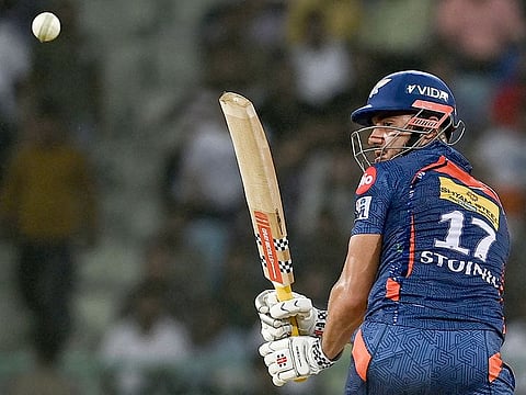 Lucknow Super Giants' Marcus Stoinis watches the ball after playing a shot during the IPL match against Mumbai Indians at the Ekana Cricket Stadium in Lucknow on May 16, 2023.