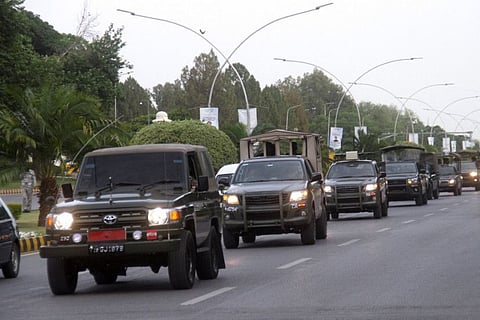 Pakistan Army vehicles patrol during a flag march, ahead of Pakistan's former Prime Minister Imran Khan's appearance in the Supreme Court in Islamabad, Pakistan May 11, 2023.