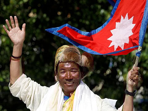 Nepali mountaineer Kami Rita Sherpa waves upon his arrival after climbing Mount Everest for the 24th time in 2019.