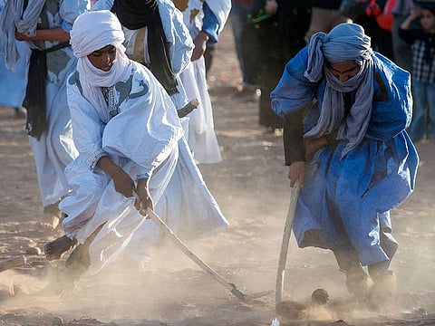 Locals play hockey during the 15th International Nomad Festival in Mhamid el-Ghizlane in Morocco's southern Sahara desert.