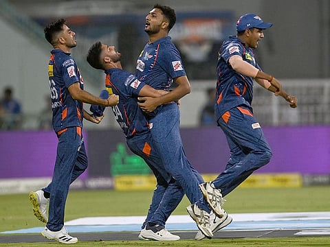 Lucknow Super Giants' Mohsin Khan (C) with teammates celebrate after their team win in the IPL match Mumbai Indians at the Ekana Cricket Stadium in Lucknow on May 16, 2023.