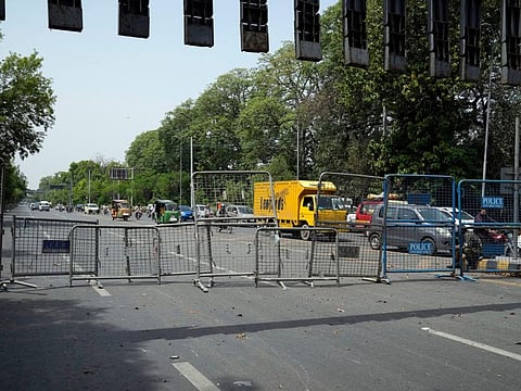 Pakistani security officials close a road outside the former Prime Minister Imran Khan's residence in Lahore, on May 18, 2023.