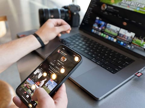 Adam Botkin, a football TikTok influencer, edits a video for a post at a Chipotle Mexican Grill while eating dinner in Missoula, on May 3, 2023. Botkin, a former walk-on place kicker and punter for the Montana Grizzlies, gained notoriety on the social media platform after videos of him performing kicking tricks went viral.