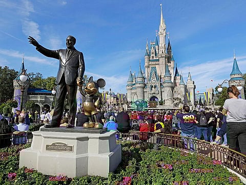 A statue of Walt Disney and Micky Mouse stands in front of the Cinderella Castle at the Magic Kingdom at Walt Disney World in Lake Buena Vista, Florida.