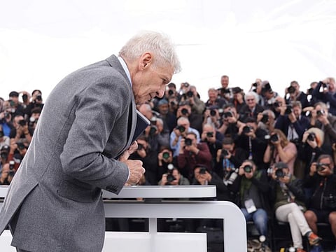 Harrison Ford poses for photographers with his honorary Palme d'Or at the photo call for the film 'Indiana Jones and the Dial of Destiny' at the 76th international film festival, Cannes, southern France, May 19, 2023.