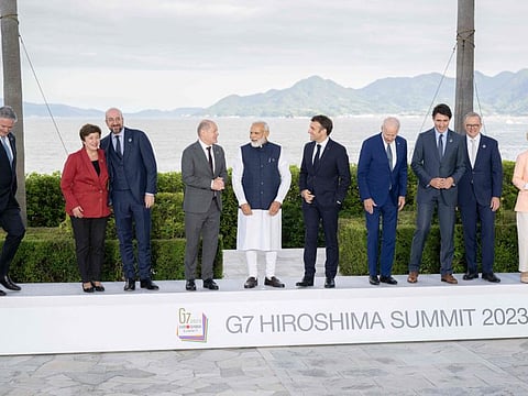 (From left) Secretary-General of the Organisation for Economic Co-operation and Development (OECD) Mathias Cormann, Managing Director of the IMF Kristalina Georgieva, Germany's Chancellor Olaf Scholz, India's Prime Minister Narendra Modi, France's President Emmanuel Macron, US President Joe Biden, Canada's Prime Minister Justin Trudeau, Australia's Prime Minister Anthony Albanese and European Commission President Ursula von der Leyen in a family photo of leaders of the G7 and invited countries during the G7 Leaders' Summit in Hiroshima on May 20, 2023.