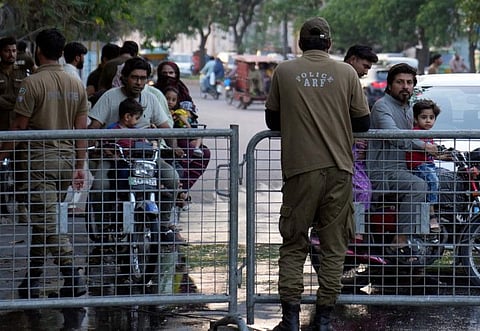 Pakistani security forces close a road outside Khan's residence in Lahore.