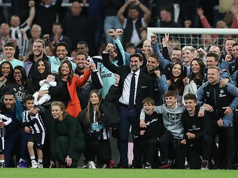 Newcastle United chairman Yasir Al Rumayyan, directors Amanda Stavely, Mehrdad Ghodoussi and Jamie Reuben pose with the players, coaching staff and families during the lap of appreciation after qualifying for the Champions League.