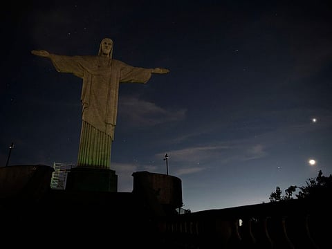 The Christ the Redeemer statue is seen without illumination to condemn racist acts against Brazilian footballer Vinicius Junior in Rio de Janeiro, Brazil.
