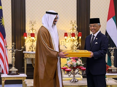 Sheikh Khaled bin Mohamed bin Zayed Al Nahyan, Crown Prince of Abu Dhabi (left) presented with a medal by His Majesty King Al-Sultan Abdullah Sultan Ahmed Shah of Malaysia