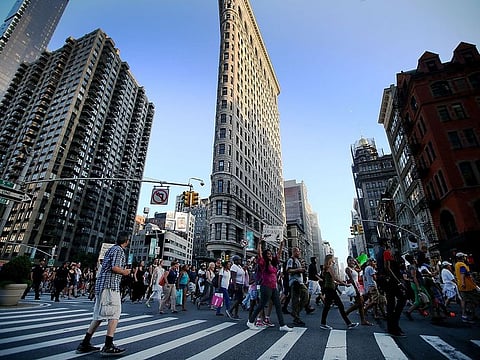 People march past the Flatiron Building in Union Square in Manhattan.