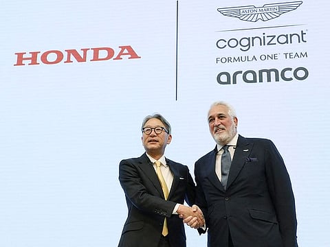 Honda Motor President Toshihiro Mibe (L) shakes hands with Aston Martin F1 Executive Chairman Lawrence Stroll during a press conference in Tokyo on May 24, 2023. Honda engines will get to power Aston Martin, in a major win for the Japanese auto company.