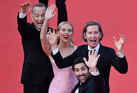 US actor Tom Hanks, US actress Scarlett Johansson, US film director Wes Anderson and US actor Jason Schwartzman wave as they arrive for the screening of the film "Asteroid City" during the 76th edition of the Cannes Film Festival in Cannes, southern France, on May 23, 2023.