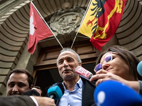 Tariq Ramadan answers journalists' questions as he leaves Geneva courthouse between his lawyers Theo Badan (left) and Yael Hayat on May 24, 2023, after he was acquitted at the end of his trial for "rape and sexual coercion" in a case dating back 15 years.