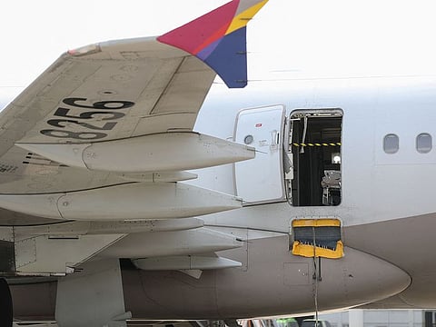 An opened door of an Asiana Airlines plane is seen at Daegu International Airport in Daegu, after it was manually opened by a passenger just 200 metres above the ground before landing causing some to have breathing difficulty but with no major injuries.