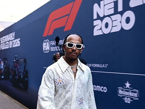Mercedes' British driver Lewis Hamilton walks in the the paddock ahead of the Monaco Grand Prix.