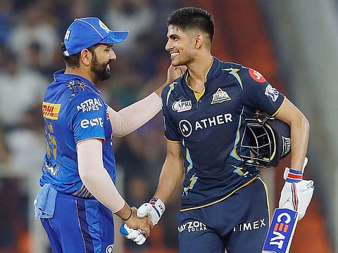 Shubman Gill of the Gujarat Titans is congratulated by Mumbai Indians skipper Rohit Sharma on completing his century during Qualifier 2 in the Indian Premier League 2023 at Narendra Modi Stadium in Ahmedabad on May 26, 2023. The 129 was Gill’s third century in four matches.