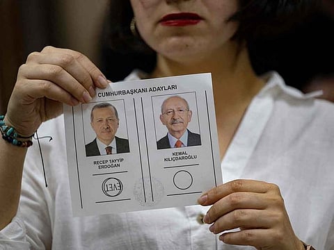 An electoral official holds up a vote during counting on the day of the second round of the presidential election in Istanbul on May 28, 2023.